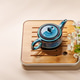 Blue teapot with blossom branch on wooden tray Blue teapot with blossom branch on wooden tray - PhotoDune Item for Sale