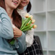 Woman receiving tulips in a heartfelt moment Woman receiving tulips in a heartfelt moment - PhotoDune Item for Sale