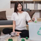 Sustainability. Young woman recycling plastic bottles at home for environmental responsibility. Sustainability. Young woman recycling plastic bottles at home for environmental responsibility. - PhotoDune Item for Sale
