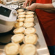 Mature Caucasian senior woman preparing handmade tarts in a bright professional bakery kitchen. Mature Caucasian senior woman preparing handmade tarts in a bright professional bakery kitchen. - PhotoDune Item for Sale