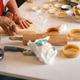 Senior Caucasian woman prepares fresh pastry dough on a kitchen counter at home. Senior Caucasian woman prepares fresh pastry dough on a kitchen counter at home. - PhotoDune Item for Sale