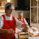 Senior Caucasian woman making fresh pasta with a rolling machine in a kitchen. Senior Caucasian woman making fresh pasta with a rolling machine in a kitchen. - PhotoDune Item for Sale