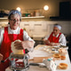 Senior Caucasian women making fresh dough with pasta machine in commercial kitchen. Senior Caucasian women making fresh dough with pasta machine in commercial kitchen. - PhotoDune Item for Sale
