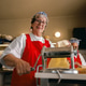 Senior Caucasian woman happily making fresh pasta with machine in cozy home kitchen Senior Caucasian woman happily making fresh pasta with machine in cozy home kitchen - PhotoDune Item for Sale