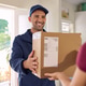 Smiling and friendly delivery man delivering parcel Smiling and friendly delivery man delivering parcel - PhotoDune Item for Sale