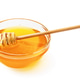 Golden honey in glass bowl with wooden dipper Golden honey in glass bowl with wooden dipper - PhotoDune Item for Sale