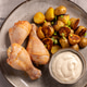 Fried Chicken Drumsticks with Baked Potatoes and Sauce on a Ceramic Plate Fried Chicken Drumsticks with Baked Potatoes and Sauce on a Ceramic Plate - PhotoDune Item for Sale