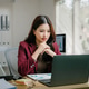 Young businesswoman analyzing data on laptop in office Young businesswoman analyzing data on laptop in office - PhotoDune Item for Sale