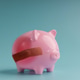 Piggy bank with bandage on pastel background,Economic crisis Piggy bank with bandage on pastel background,Economic crisis - PhotoDune Item for Sale