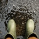 POV shot of person with rain boots standing on wet ground during rainfall, with raindrops in Rainy s POV shot of person with rain boots standing on wet ground during rainfall, with raindrops in Rainy s - PhotoDune Item for Sale