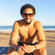 Young latino man enjoying summer day at beach Young latino man enjoying summer day at beach - PhotoDune Item for Sale
