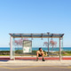 Latino man rollerblading resting at beach bus stop Latino man rollerblading resting at beach bus stop - PhotoDune Item for Sale