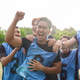 Excited soccer player raising fist to celebrate victory with the team. Success, teamwork, and active Excited soccer player raising fist to celebrate victory with the team. Success, teamwork, and active - PhotoDune Item for Sale