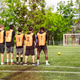 Soccer team players standing in defense wall on artificial turf field. Football training practice ma Soccer team players standing in defense wall on artificial turf field. Football training practice ma - PhotoDune Item for Sale