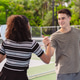 Pickleball doubles team celebrating victory on outdoor court. Smiling man and woman greeting during Pickleball doubles team celebrating victory on outdoor court. Smiling man and woman greeting during - PhotoDune Item for Sale