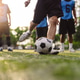 Close up low angle view of a soccer player kicking the ball on the turf field. Action, sports compet Close up low angle view of a soccer player kicking the ball on the turf field. Action, sports compet - PhotoDune Item for Sale