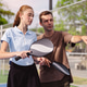 Pickleball doubles team discussing strategy on outdoor sports court. Man coaching and talking to wom Pickleball doubles team discussing strategy on outdoor sports court. Man coaching and talking to wom - PhotoDune Item for Sale
