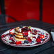 Stack of cottage cheese pancakes syrniki with berry sauce and mint close up Stack of cottage cheese pancakes syrniki with berry sauce and mint close up - PhotoDune Item for Sale