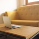 Open laptop on coffee table in modern living room interior without people Open laptop on coffee table in modern living room interior without people - PhotoDune Item for Sale