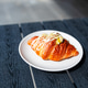 Savory breakfast croissant sandwich with scrambled egg and sauce close up Savory breakfast croissant sandwich with scrambled egg and sauce close up - PhotoDune Item for Sale