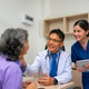 Doctor comforting mature patient as nurse holds digital tablet Doctor comforting mature patient as nurse holds digital tablet - PhotoDune Item for Sale