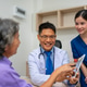 Doctor pointing to digital tablet as patient and nurse listen Doctor pointing to digital tablet as patient and nurse listen - PhotoDune Item for Sale