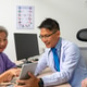 Doctor sharing tablet results with attentive mature patient in clinic Doctor sharing tablet results with attentive mature patient in clinic - PhotoDune Item for Sale