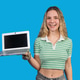 Smiling young woman showing laptop computer screen Smiling young woman showing laptop computer screen - PhotoDune Item for Sale