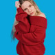 Young blonde woman posing in red off-the-shoulder sweater Young blonde woman posing in red off-the-shoulder sweater - PhotoDune Item for Sale