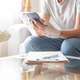 Woman with hand splint using smartphone and medical documents Woman with hand splint using smartphone and medical documents - PhotoDune Item for Sale