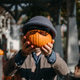 Man holding a small pumpkin wearing sunglasses and a wool hat in front of his face. Wholesome Hallow Man holding a small pumpkin wearing sunglasses and a wool hat in front of his face. Wholesome Hallow - PhotoDune Item for Sale