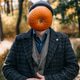 Man standing in a forest path with a pumpkin obscuring his face and wearing a dark hat. Visual metap Man standing in a forest path with a pumpkin obscuring his face and wearing a dark hat. Visual metap - PhotoDune Item for Sale