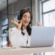 Smiling woman wearing headphones having video call on laptop, making ok gesture, enjoying remote wor Smiling woman wearing headphones having video call on laptop, making ok gesture, enjoying remote wor - PhotoDune Item for Sale