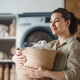 Happy Woman Holding Laundry Basket in Modern Home Laundry Room Happy Woman Holding Laundry Basket in Modern Home Laundry Room - PhotoDune Item for Sale