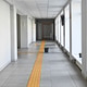 Bright school corridor with yellow tactile path on tiled floor, Bright school corridor with yellow tactile path on tiled floor, - PhotoDune Item for Sale