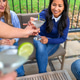Portrait of smiling hispanic female taking lime cocktail during celebration on terrace Portrait of smiling hispanic female taking lime cocktail during celebration on terrace - PhotoDune Item for Sale