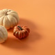 Three decorative pumpkins on orange background with copy space Three decorative pumpkins on orange background with copy space - PhotoDune Item for Sale