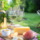 Summer picnic with white wine cheese peaches honey and grapes in green backyard garden Summer picnic with white wine cheese peaches honey and grapes in green backyard garden - PhotoDune Item for Sale