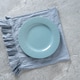 Empty blue ceramic plate on linen napkin over stone background Empty blue ceramic plate on linen napkin over stone background - PhotoDune Item for Sale