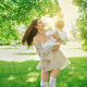 Happy mother joyfully plays with her baby in green park on sunny day Happy mother joyfully plays with her baby in green park on sunny day - PhotoDune Item for Sale