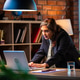 Senior Indian female executive standing at desk and leaning on laptop in contemporary office space Senior Indian female executive standing at desk and leaning on laptop in contemporary office space - PhotoDune Item for Sale