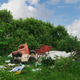 Garbage is scattered around old furniture and waste in a natural setting on a sunny day Garbage is scattered around old furniture and waste in a natural setting on a sunny day - PhotoDune Item for Sale