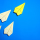 Yellow Paper Airplane Leading White Paper Airplanes on Blue Background Yellow Paper Airplane Leading White Paper Airplanes on Blue Background - PhotoDune Item for Sale