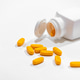 Yellow Pills Spilled from Medicine Bottle Isolated on White Background Yellow Pills Spilled from Medicine Bottle Isolated on White Background - PhotoDune Item for Sale