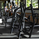 Row Of Empty Bench Press Machines With Barbells And Weight Plates Sits In Gym Facility Row Of Empty Bench Press Machines With Barbells And Weight Plates Sits In Gym Facility - PhotoDune Item for Sale