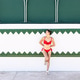 Isolated young asian woman in swimsuit leaning over beach house Isolated young asian woman in swimsuit leaning over beach house - PhotoDune Item for Sale