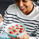 Happy young black woman eating healthy breakfast bowl sitting on sofa at home Happy young black woman eating healthy breakfast bowl sitting on sofa at home - PhotoDune Item for Sale