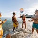 Friends playing beach ball enjoying summer vacation by the sea Friends playing beach ball enjoying summer vacation by the sea - PhotoDune Item for Sale