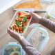 Woman holding a healthy pasta meal prep container Woman holding a healthy pasta meal prep container - PhotoDune Item for Sale