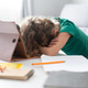 Tired schoolgirl resting her head on the desk during online learning at home Tired schoolgirl resting her head on the desk during online learning at home - PhotoDune Item for Sale